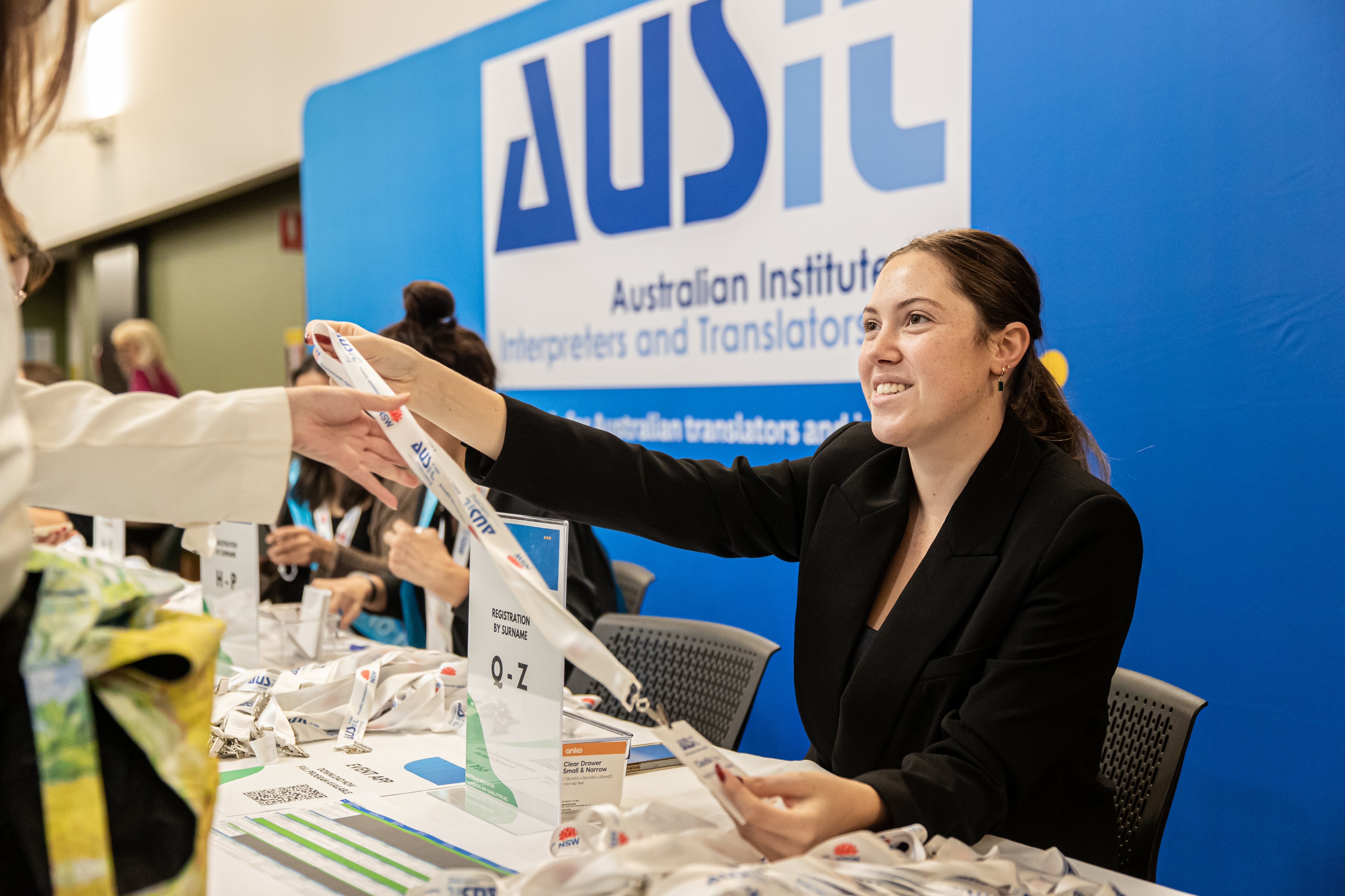 Event Staff Issuing Lanyard to Delegate at AUSIT Conference Sydney