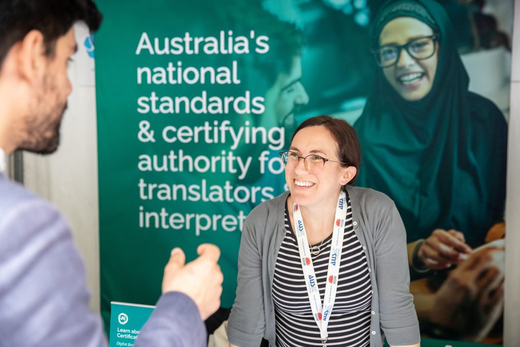 AUSIT Conference Delegate Chatting to Attendee at Exhibitor Booth