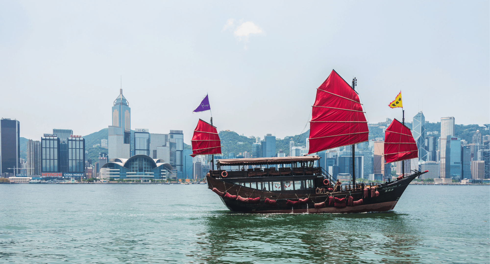 Hong Kong traditional boat sailing with city backdrop - Group Offsite Experience Business Event Destination